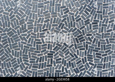 Full frame background texture of stippled rectangular grey mosaic tiles in a random scatter and pattern for decor concepts Stock Photo