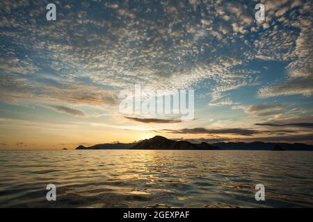 Sunset sky filled with cirrocumulus clouds above Padar island Stock Photo