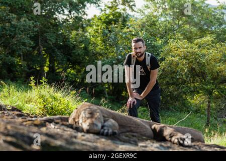 A man standing next to Komodo dragon  Stock Photo