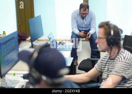 Berlin, Germany. 16th Aug, 2021. Julian Reichelt (M), editor-in-chief of "Bild", looks at his smartphone in the control room of the TV channel "Bild". The new TV channel "Bild" of the Axel Springer media group goes on air for the first time on August 22. Credit: Jörg Carstensen/dpa/Ģ����ý Live News Stock Photo