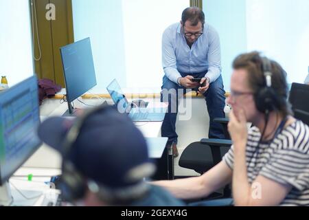 Berlin, Germany. 16th Aug, 2021. Julian Reichelt (M), editor-in-chief of "Bild", looks at his smartphone in the control room of the TV channel "Bild". The new TV channel "Bild" of the Axel Springer media group goes on air for the first time on August 22. Credit: Jörg Carstensen/dpa/Ģ����ý Live News Stock Photo