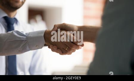 Close up view two business men shaking hands Stock Photo