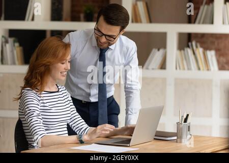 Friendly colleagues talk during workday in modern office Stock Photo