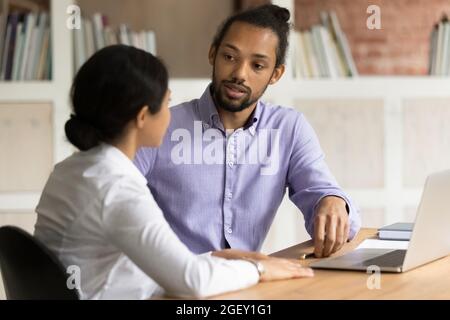 Multiracial workmates working on project at workplace with computer Stock Photo