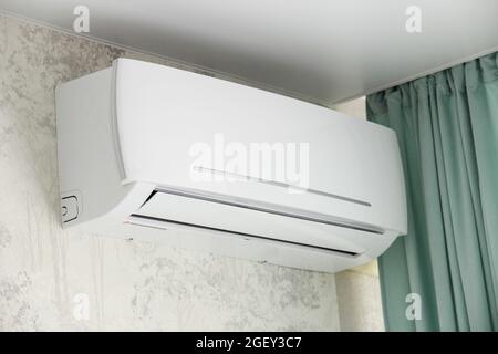 Indoor unit of the air conditioner in the room on the wall Stock Photo