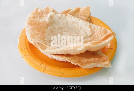 Chebureks on yellow paper disposable plate isolated on white background Stock Photo