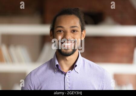 African male employee head shot portrait in modern office Stock Photo