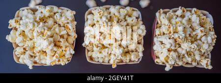Popcorn in red and white container on a dark background BANNER, LONG FORMAT Stock Photo