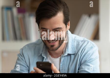 Man read message on cellphone feels pleased getting good news Stock Photo