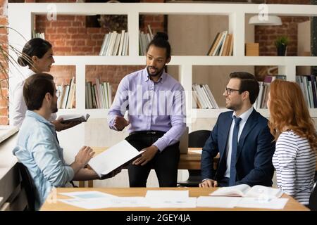 African ethnicity team leader led group briefing in modern office Stock Photo