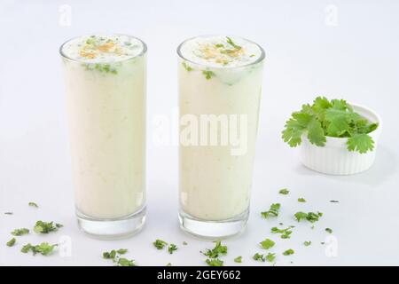 Buttermilk drink in glass cups on white background Stock Photo