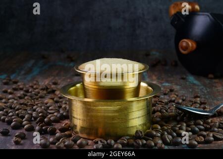 Indian filter coffee served in a brass cup Stock Photo