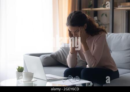 Young woman touch temples suffers from headache Stock Photo