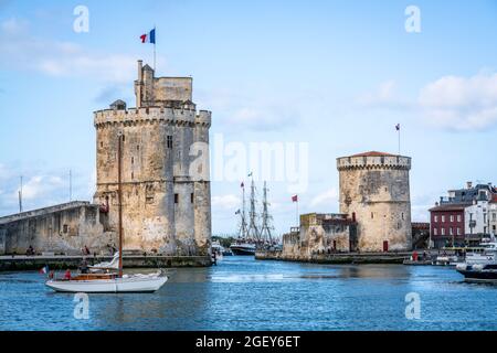 The Chain and Saint Nicolas towers of La Rochelle during summer with blue sky marking the entryway of the old port of La Rochelle France Stock Photo