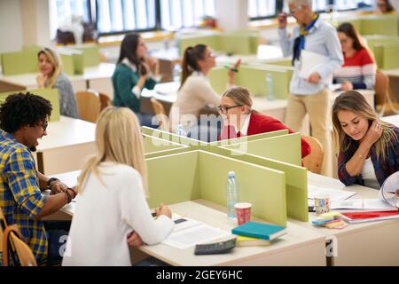 Students having good time at a lecture in a classroom Stock Photo