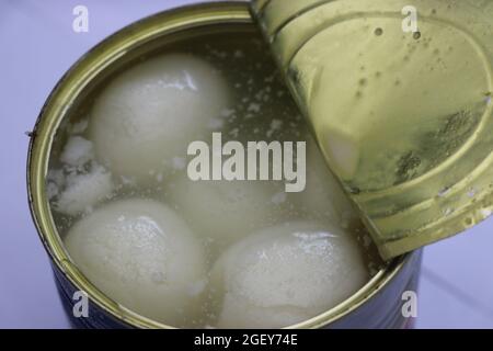 White rasgulla sweets view from a freshly opened can. Spongy rasgulla which is an Indian dessert in a container Stock Photo