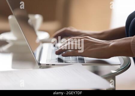 Close up view female hands typing on laptop Stock Photo