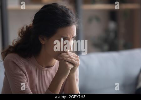 Closeup upset face of Latina woman deep in sad thoughts Stock Photo