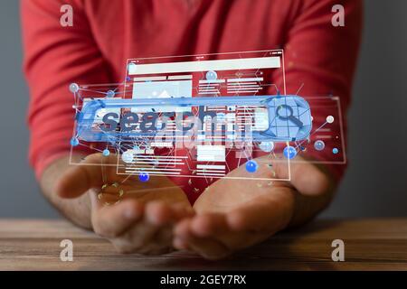A digital concept of search engine optimization in hands Stock Photo