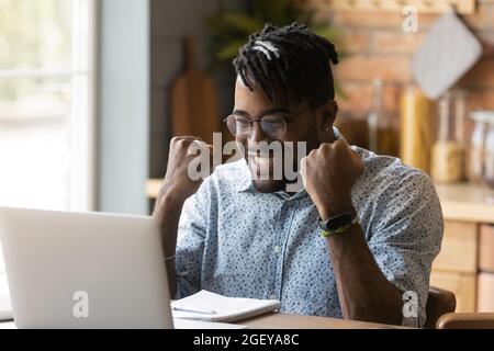 Happy student guy excited with good news, reading email letter Stock Photo