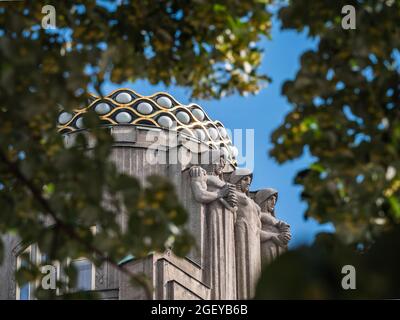 Prague, Czech Republic - July 4 2021: Three Allegorical Figures on Koruna Palace by Vojtech Sucharda, a late Art Nouveau Building on Wenceslas Square. Stock Photo