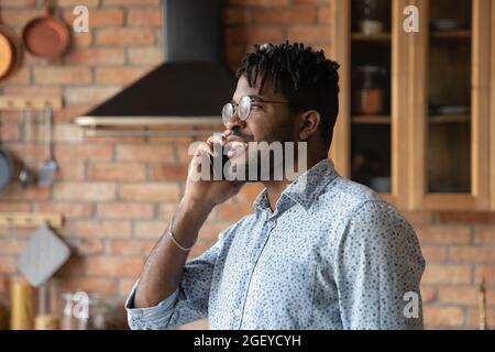 Handsome millennial African American hipster guy making telephone call Stock Photo