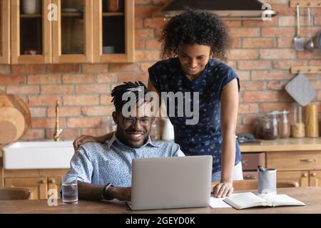 Happy African American couple watching content on laptop Stock Photo