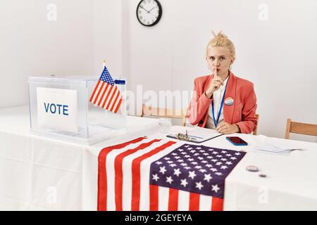 Beautiful caucasian woman working at political campaign asking to be quiet with finger on lips. silence and secret concept. Stock Photo