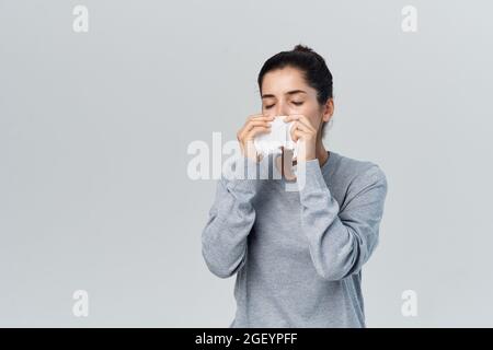 disgruntled woman runny nose cold health problems treatment Stock Photo