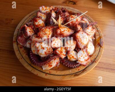 Pulpo a la gallega in Spanish meaning Galician-style octopus or polbo a feira meaning fair-style octopus in gallego. Stock Photo
