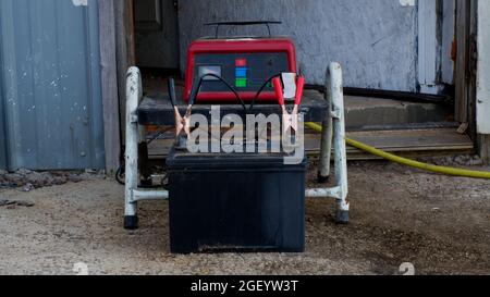 A 12 Volt Car Battery and a Charger Stock Photo