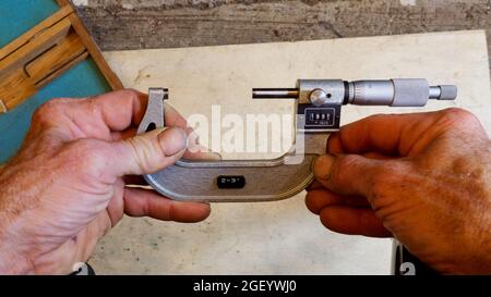 A Person Holding a Micrometer Stock Photo