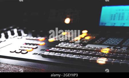 close up on illuminated buttons of professional equipment of digital Control panel electronic device, video and audio mixer switch of Television Broad Stock Photo