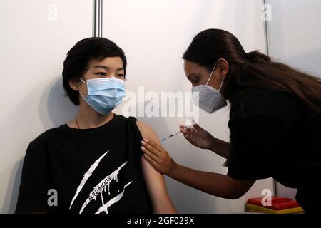 Lisbon, Portugal. 21st Aug, 2021. A boy receives his first dose of the COVID-19 vaccine at a vaccination center in Oeiras, Portugal, Aug. 21, 2021. Portugal started inoculating adolescents aged 12 to 15 against COVID-19. The country has reached its target of fully vaccinating 70 percent of its population against COVID-19. Credit: Pedro Fiuza/Xinhua/Alamy Live News Stock Photo