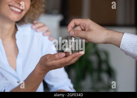 Close up of male relator give keys to happy woman Stock Photo