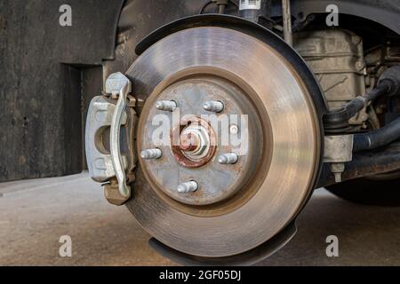 Vehicle brakes parts. Caliper and rotor on car. Brake inspection, repair, service and maintenance concept Stock Photo