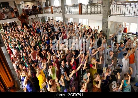 Large group of Hare Krishna parishioners praying in a temple, hands up. April 3, 2017. The Krishna temple, Kiyv, Ukraine Stock Photo