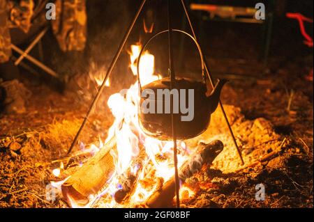 Campfire kettle closeup with blurred bonfire in the background Stock Photo  - Alamy