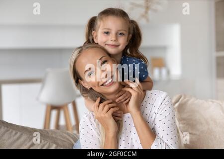 Portrait of sweet little girl hugging happy best mom Stock Photo