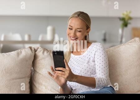 Happy pretty millennial woman taking selfie, photo on mobile phone Stock Photo