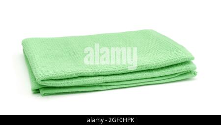Folded green cotton towel isolated on white. Stock Photo
