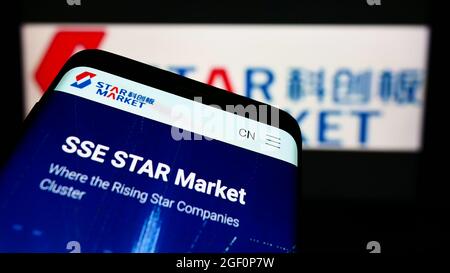 Smartphone with website of Shanghai Stock Exchange STAR Market on screen in front of business logo. Focus on top-left of phone display. Stock Photo