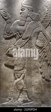 Assyrian relief of protective deity, 883-859 BC, from Palace of Nimrud, Iraq. On display in the Fitzwilliam Museum, Cambridge, England, UK Stock Photo