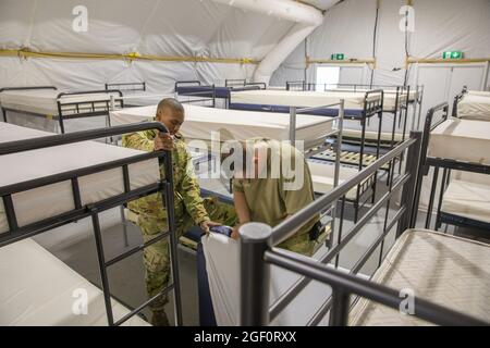 U.S. Soldiers prepare bedding for the possibility of supporting incoming Afghan evacuees  at Grafenwoehr Training Area, Germany, Aug. 22, 2021. U.S. Army Europe and Africa is working hand-in-hand with host nations, the joint force and interagency partners to provide temporary lodging, medical and logistical support as part of Operation Allies Refuge.     Operation Allies Refuge is facilitating the quick, safe evacuation of U.S. citizens, Special Immigrant Visa applicants and other at-risk Afghans from Afghanistan. (U.S. Army photo by Pfc. Jacob Bradford via American PhotoArchive/ALAMY) Stock Photo