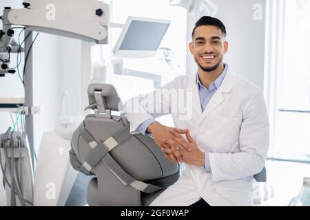 Dental Services. Portrait Of Professional Arab Stomatologist Doctor Posing At Workplace Stock Photo