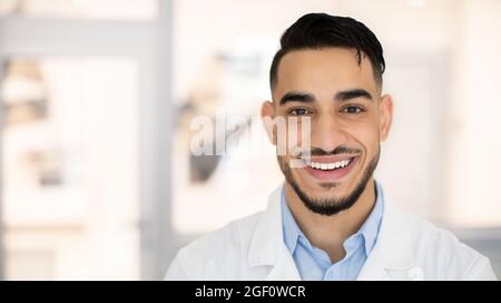 Closeup Portrait Of Smiling Young Middle Eastern Therapist Doctor In Uniform Stock Photo