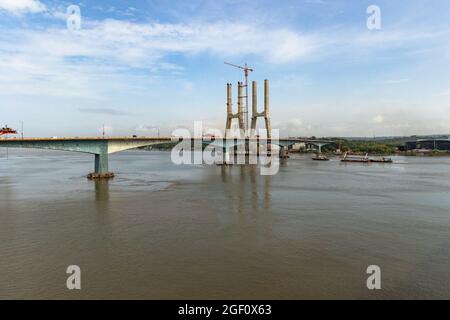 Under construction Four Lane New Zuari Bridge - Manohar Setu, undertaken by Dilip Buildcon Ltd. as seen from train while travelling on Konkan Railway. Stock Photo