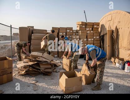 U.S. service members unload and breakdown boxes of bedding for qualified evacuees Aug. 21, 2021, at an undisclosed location somewhere in Southwest Asia. As part of the evacuation of Afghanistan, the evacuees departed Hamid Karzai International Airport, Kabul, Afghanistan on multiple military aircraft. (U.S. Air Force photo by Staff Sgt. Kylee Gardner via American PhotoArchive/ALAMY) Stock Photo