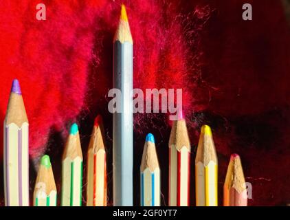 Selective focus close up at color pens lying on a red felt surface Stock Photo