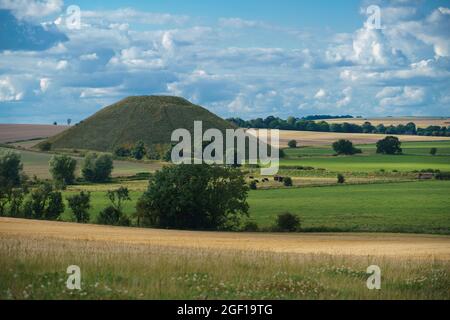 view across open farmland of Silbury Hill (prehistoric artificial chalk mound) Avebury Wiltshire UK, a UNESCO World Heritage Site Stock Photo